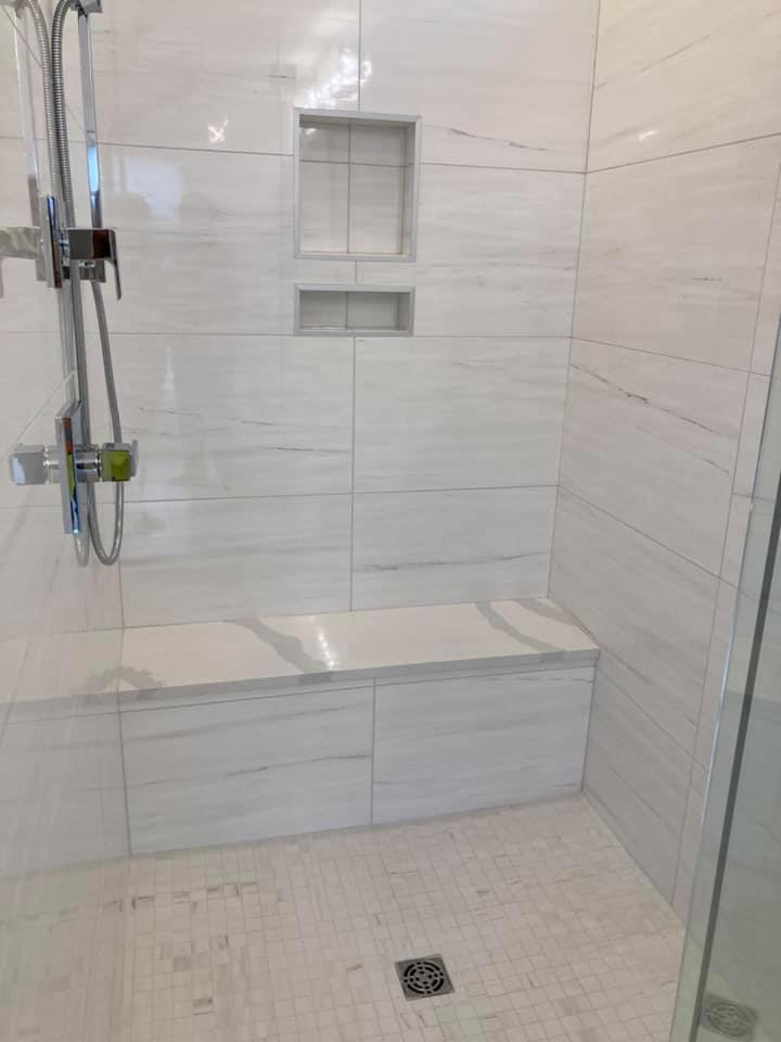 completed kerdi shower with bench, drain, and niches